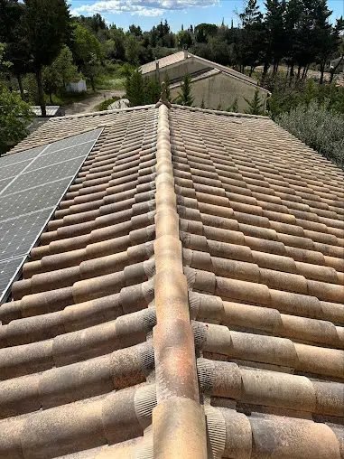 Toiture en tuiles entretenue autour de panneaux photovoltaïques
